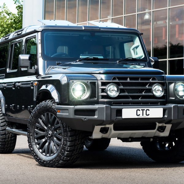 Black Ineos Grenadier With The Front Sump guard, Front grille with light mounts & mesh, Side vents , side door entry steps, foldable sun roof  and wheels Tailored by Kahn  